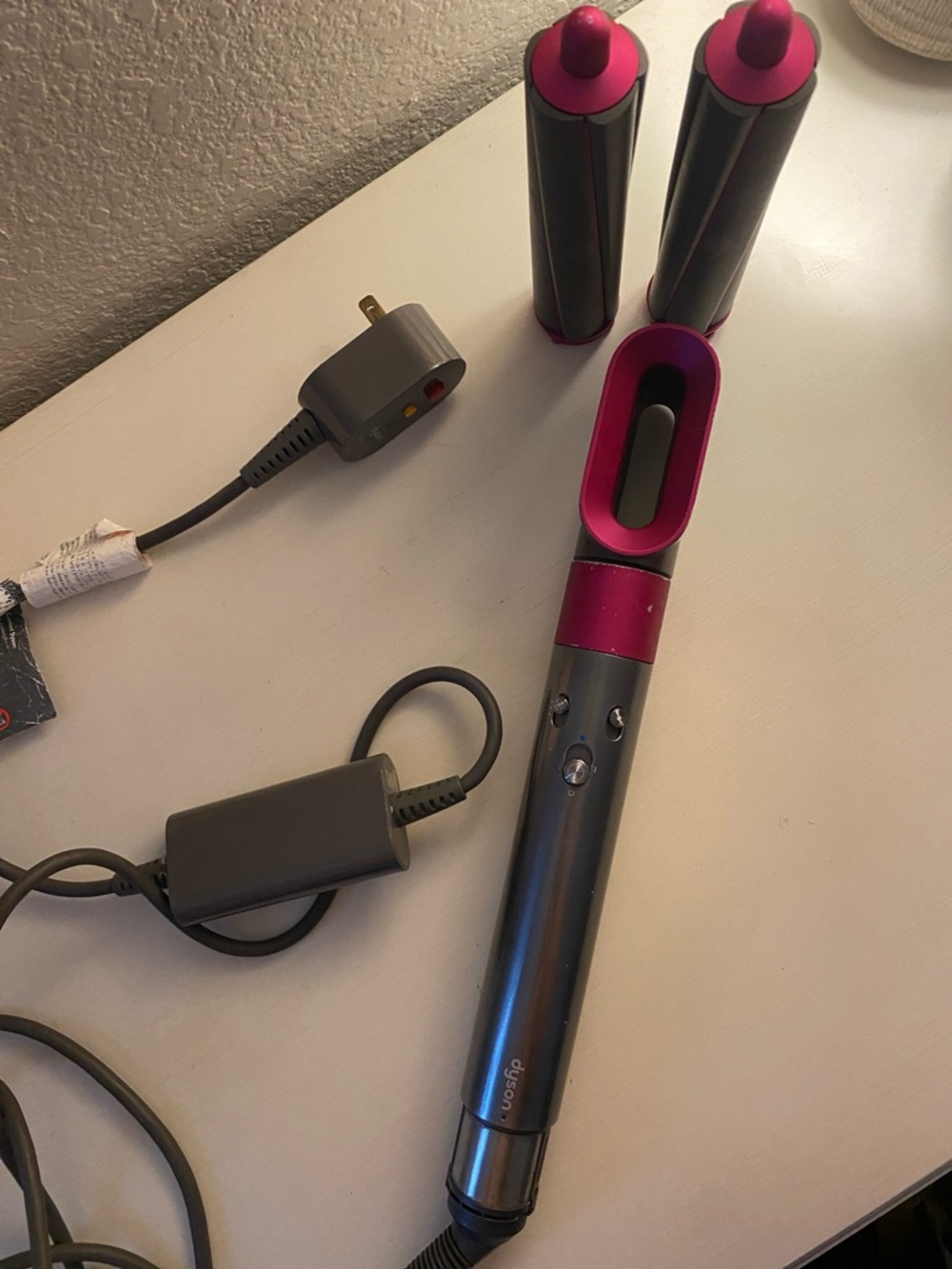 Dyson styling wand in gray with pink accents